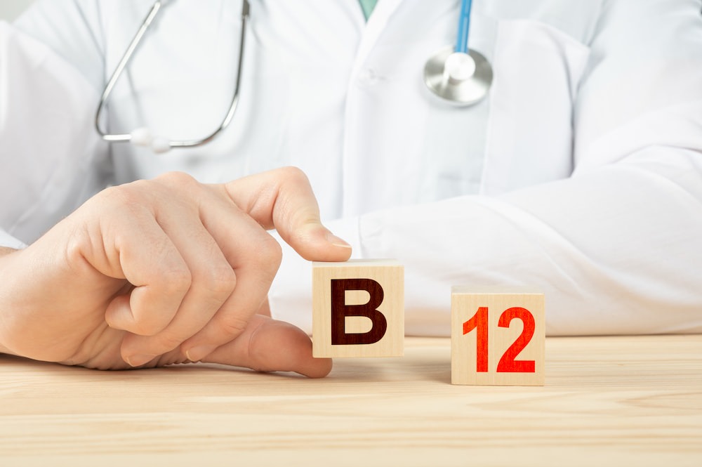 Doctor holding up blocks that say B12