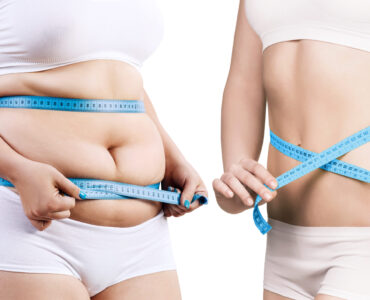 Two Women Holding Measuring Tape Around Their Torso To Show Weight Loss